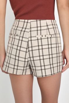 You're sure to win best style when you've got an adorable look like the Lulus Superlative Sweetie Beige and Brown Plaid Skort! Lightweight woven fabric, with a classic plaid pattern throughout, shapes this darling skort that has a high waist and a skirt-style overlay at the front with flirty, double-notched hems and decorative welt pockets at back. Attached shorts complete the look. Hidden zipper/clasp at side. Fit: This garment fits true to size. Length: Mid-thigh. Size medium measures 13.75" from waist to hem. Inseam: 2.50 Front Rise: 12.75 Waist: Fitted - very fitted at natural waist. Hip: Loosely Fitted. Fabric: Fabric has no stretch. Unlined. 97% Polyester, 3% Spandex. Hand Wash Cold. Do Not Bleach. Line Dry. Iron Low Heat. Imported. Lulus | Superlative Sweetie Beige and Brown Plaid S Trendy Fitted Plaid Shorts, Trendy Plaid Bottoms For Day Out, Chic Fitted Plaid Shorts, Preppy Cotton Bottoms For Fall, Fitted Plaid Casual Shorts, Fitted Casual Plaid Shorts, Chic Plaid Cotton Shorts, Chic Plaid Short Bottoms, Trendy Plaid Shorts For Day Out