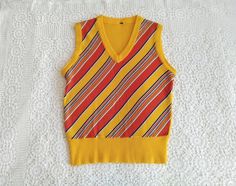 Vintage from the 1970s 70s retro vest, striped mod vest, vivid colors vest, yellow spring vest, pop-art gilet, V-neck multicolor vest, V-neck summer vest, probably acrylic vest. GOOD VINTAGE CONDITION BUT THE ITEM IS NOT DRY CLEAN. Measurements laying flat : shoulders :38cm (15 inches) bust:45cm (17,5 inches) total lenght :60 cm (23,5 inches) Retro V-neck Vest For Spring, Yellow V-neck Vest For Summer, Vintage V-neck Vest For Spring, Retro V-neck Fitted Vest, Casual Yellow V-neck Vest, Yellow V-neck Vest Top, Retro Multicolor Cotton Vest, Striped Cotton Sweater Vest For Summer, Retro Fitted Summer Vest