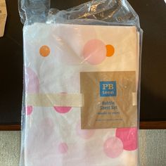 there is a plastic bag with pink and orange polka dots on it