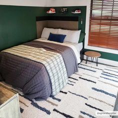 a bedroom with green walls and white carpet