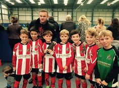 a group of young boys standing next to each other