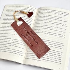 an open book with a leather tag attached to it