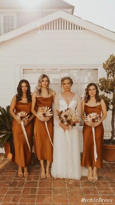 the bride and her four bridesmaids are standing in front of a white house