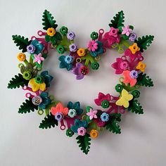 a heart made out of flowers and scissors