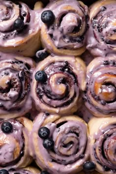 blueberry cinnamon rolls with icing and blueberries in the middle are ready to be eaten