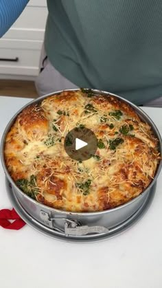 a pizza sitting on top of a metal pan covered in cheese and broccoli