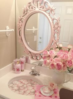 a bathroom sink with pink flowers and soaps on it