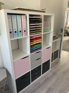 a book shelf filled with lots of books and binders on top of each other