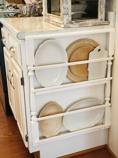 a white cabinet with plates on it in a kitchen