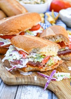 two sandwiches cut in half on a cutting board