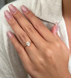 a woman's hand with a diamond ring on it