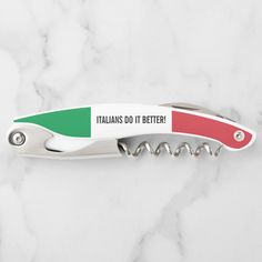 a red, green and white swiss army knife with the words italians do it better