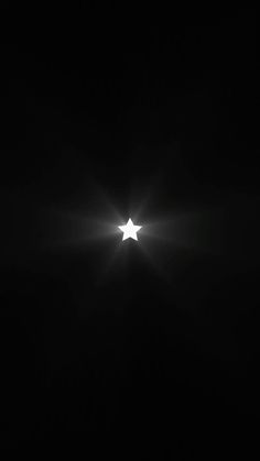 a star is shining in the dark with light coming from it's back end