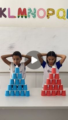 two children are playing with plastic cups