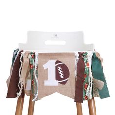 a wooden chair with a football banner on the back of it's seat cover