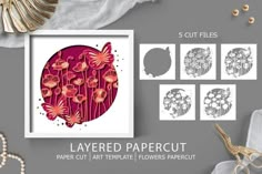 paper cut art templates with flowers and gold scissors on the table next to it