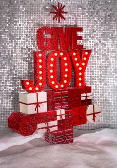 the words give joy are lit up in red and white