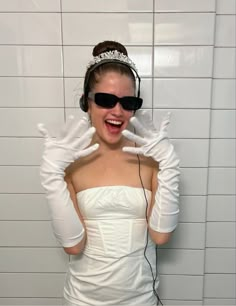 a woman in white dress wearing headphones and gloves