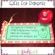 an apple sitting on top of a table next to a sign that says gifts for parents