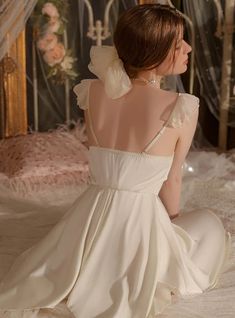 Venerated for its timeless elegance, this nightgown is a masterpiece of design. The exquisite off-white fabric exudes a soft glow, reminiscent of moonlight on a serene night. Delicate pearl-like adornments cascade from the sweetheart neckline, adding a layer of sophistication and grace. The fitted bodice transitions into a flowing skirt, creating a silhouette that celebrates the female form. Sheer, puffed sleeves add a hint of whimsy and romance, making this gown a luxurious choice for any woman seeking to feel like royalty in her own home. It's more than a nightgown; it's a garment that blurs the lines between nightwear and haute couture.Fabric name: satinStyle: slingCollar type: V-neckSleeve length: sleevelessColor: burgundy, purple, apricot Summer French Style, Couture Fabric, Sunflower Dress, Sleeveless Dresses Casual, Team Photos, Flowing Skirt, High Neck Long Sleeve, Black Long Sleeve Dress, Pink Midi Dress