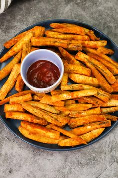 french fries with ketchup on a blue plate