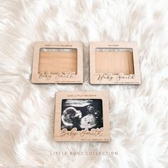 two wooden photo frames sitting on top of a white blanket