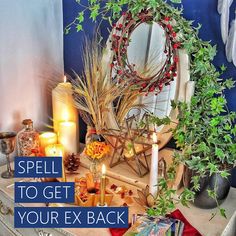 a table with candles, flowers and other items on it that says spell to get your ex back