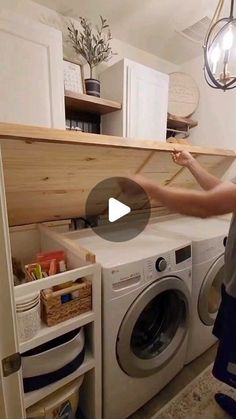 a woman standing in front of a washer and dryer