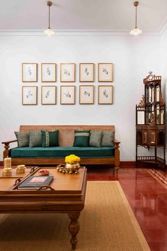 a living room filled with furniture and pictures on the wall above it's coffee table