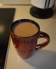 a cup of coffee sitting on top of a table