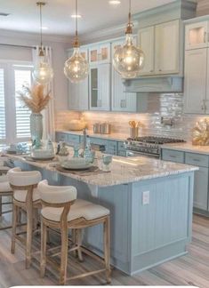 a kitchen filled with lots of counter top space next to a dining room table and chairs