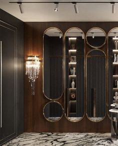 an elegant bathroom with marble flooring and black walls, along with large mirrors on the wall