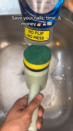 someone is using a sponge to clean the sink