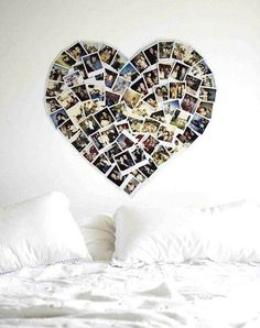 a heart shaped photo collage hangs on the wall above a bed with white pillows