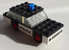 a police car made out of legos sitting on a table with the word police written on it