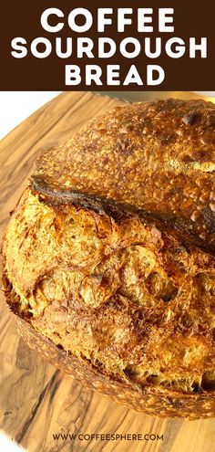 a loaf of coffee sourdough bread sitting on top of a wooden cutting board