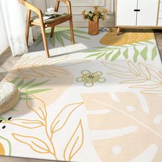 an area rug with flowers and leaves on it in the middle of a living room