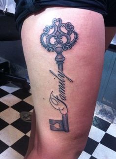 a woman's thigh with a key tattoo on it