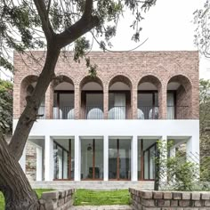 the building is made out of bricks and has multiple balconies on each level