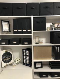 the shelves are organized with black and white boxes