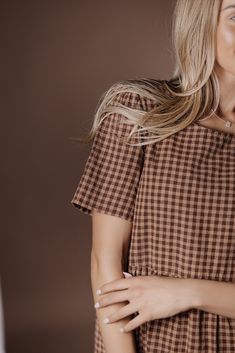 Indulge in the sophistication of the Taryn Gingham Dress on Brown. Made from 100% cotton, this midi dress boasts a modest silhouette and timeless gingham print, making it the perfect fall dress. Elevate your wardrobe with this premium piece that exudes elegance and style. 100 Cotton Model Measurements: Hips 36” Waist 25” Bust: 31”, Height 5’5.5, wearing a size small Bridesmaid Tops, Blessing Dress, Temple Dress, Boho Style Dresses, Fall Dress, Gingham Print, Gingham Dress, Romper Pants, Trending Dresses