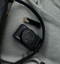 a camera sitting on top of a black bag