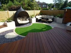 an outdoor living area with grass and wooden decking