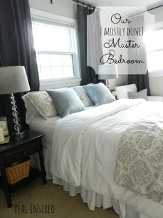 a white bed sitting in a bedroom next to a window