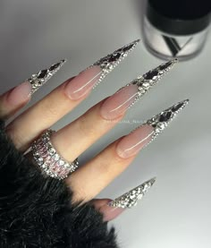 Extra Rhinestone Nails, Black Acrylic Rhinestone Nails, Blinged Out Silver Nails, Stilleto Nails Rhinestone, Stilleto Nails With Charms, Metallic Silver Nails Acrylic, Stiletto Nails Charms, Silver Bling Acrylic Nails, Blinged Out Stiletto Nails