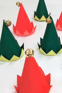 paper christmas trees with bells on them are arranged in a circular pattern and placed on top of each other