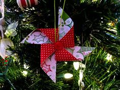 an origami star hanging from a christmas tree