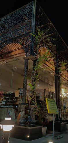 an outdoor area with lights and plants on display