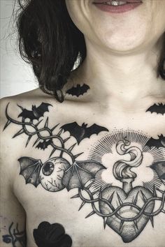 a woman with tattoos on her chest