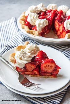 a slice of strawberry pie on a plate with a fork next to the rest of the pie